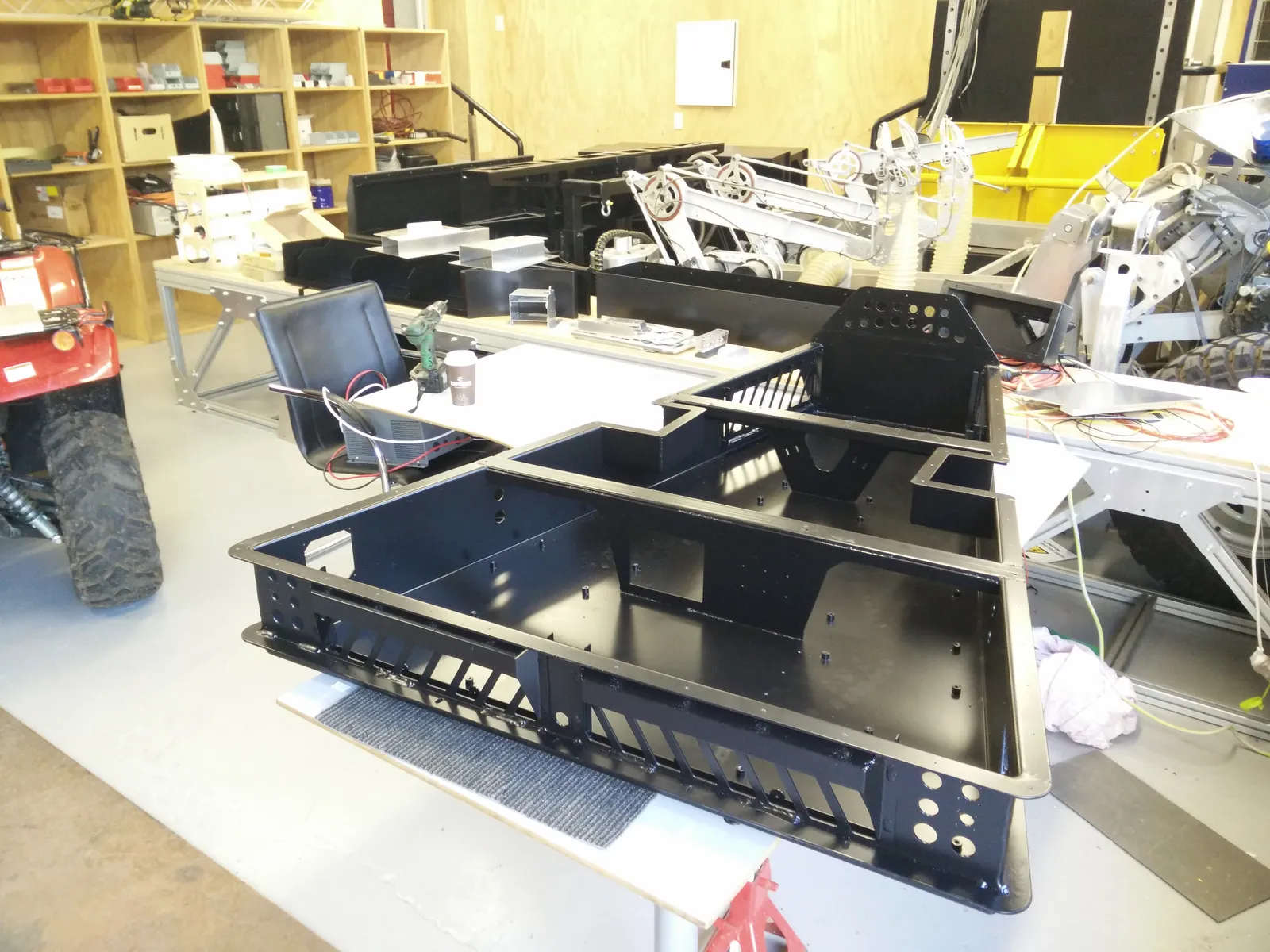 Powder-coated cabinet sections on a bench in the workshop
