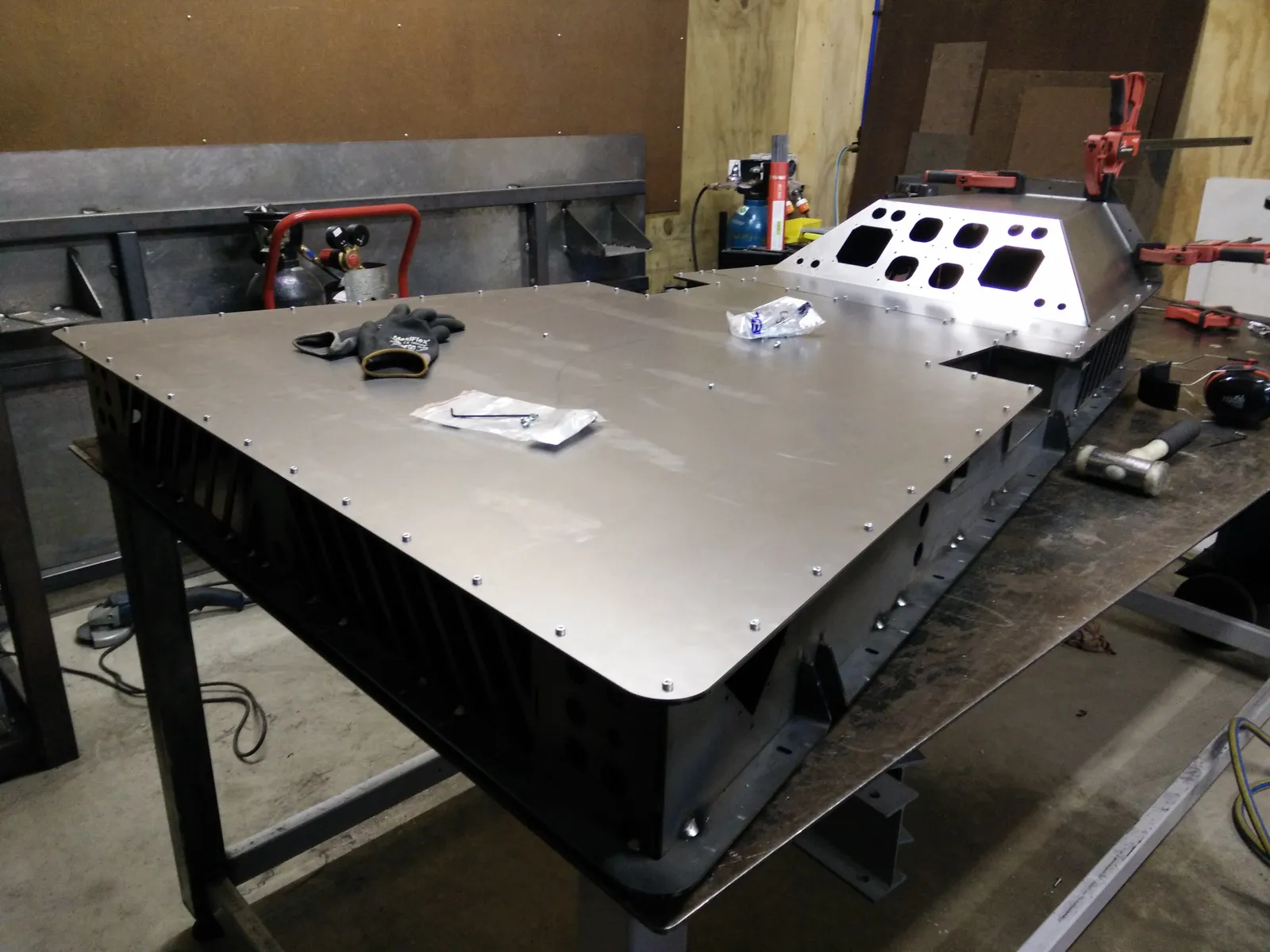 Cabinet welded up on a workbench with lid fitted, before powder coating