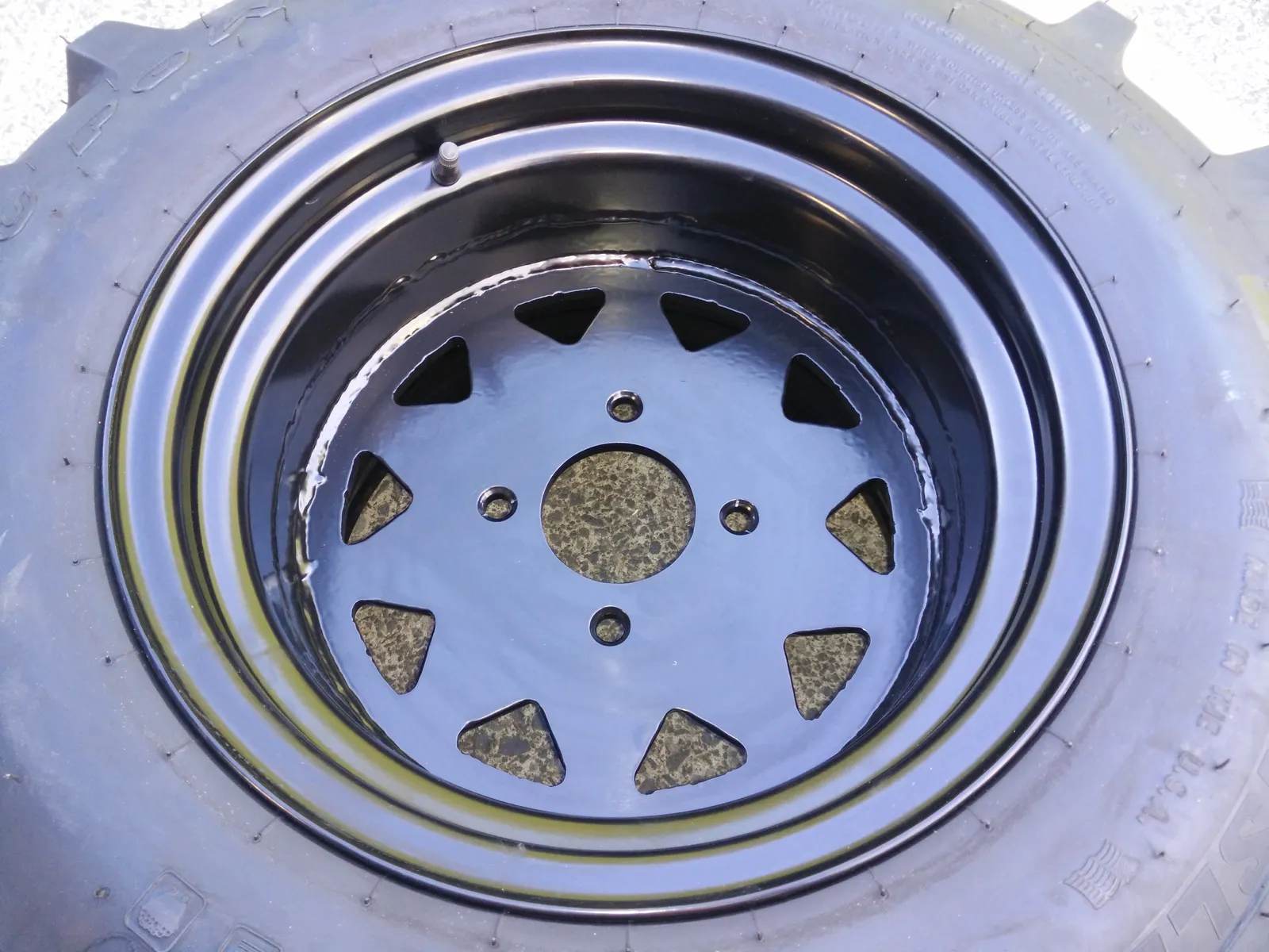 Custom wheel rim with triangular lightening holes, powder-coated black