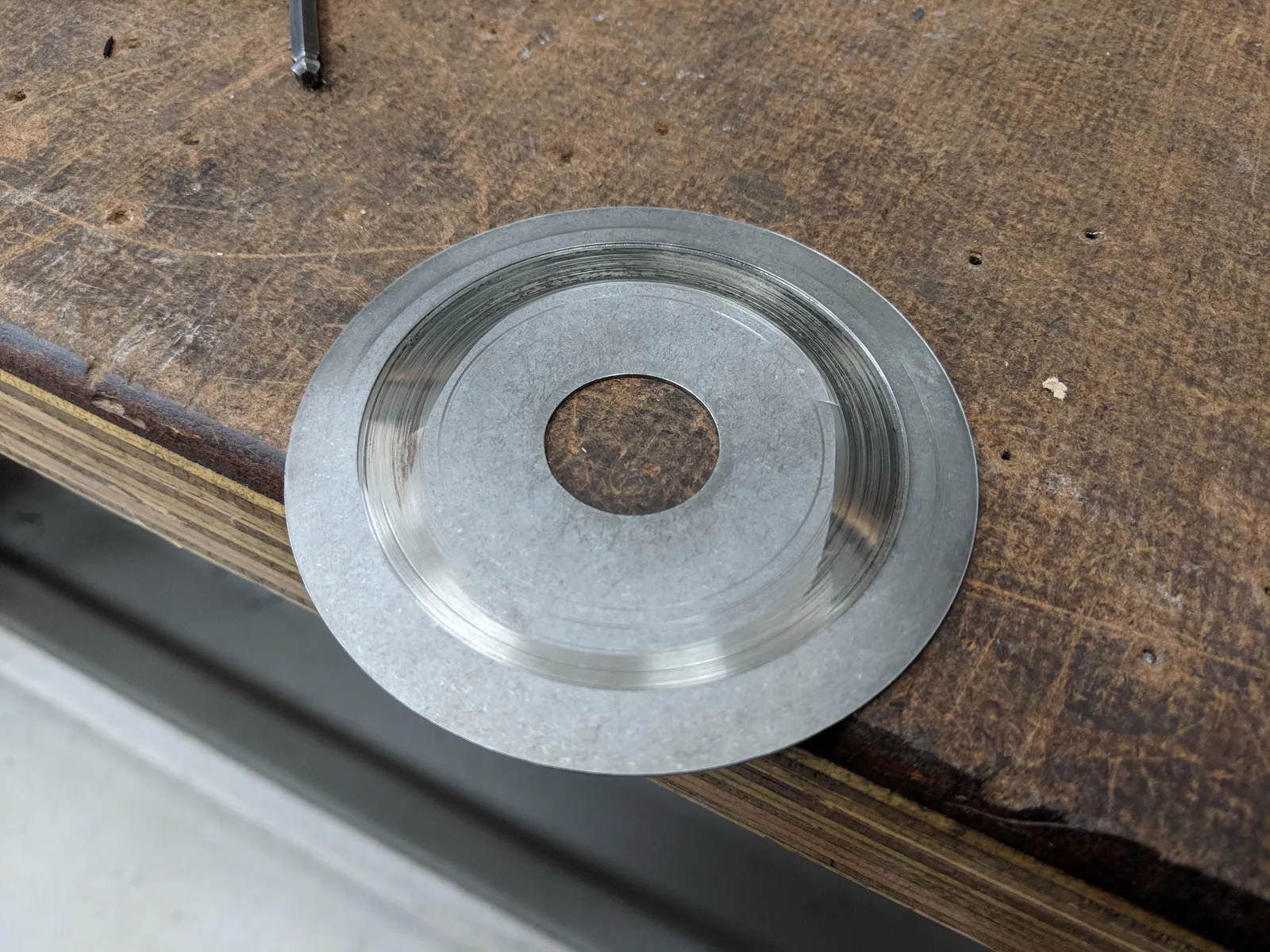 Gearbox cover plate showing concentric scrape marks from the planetary gears