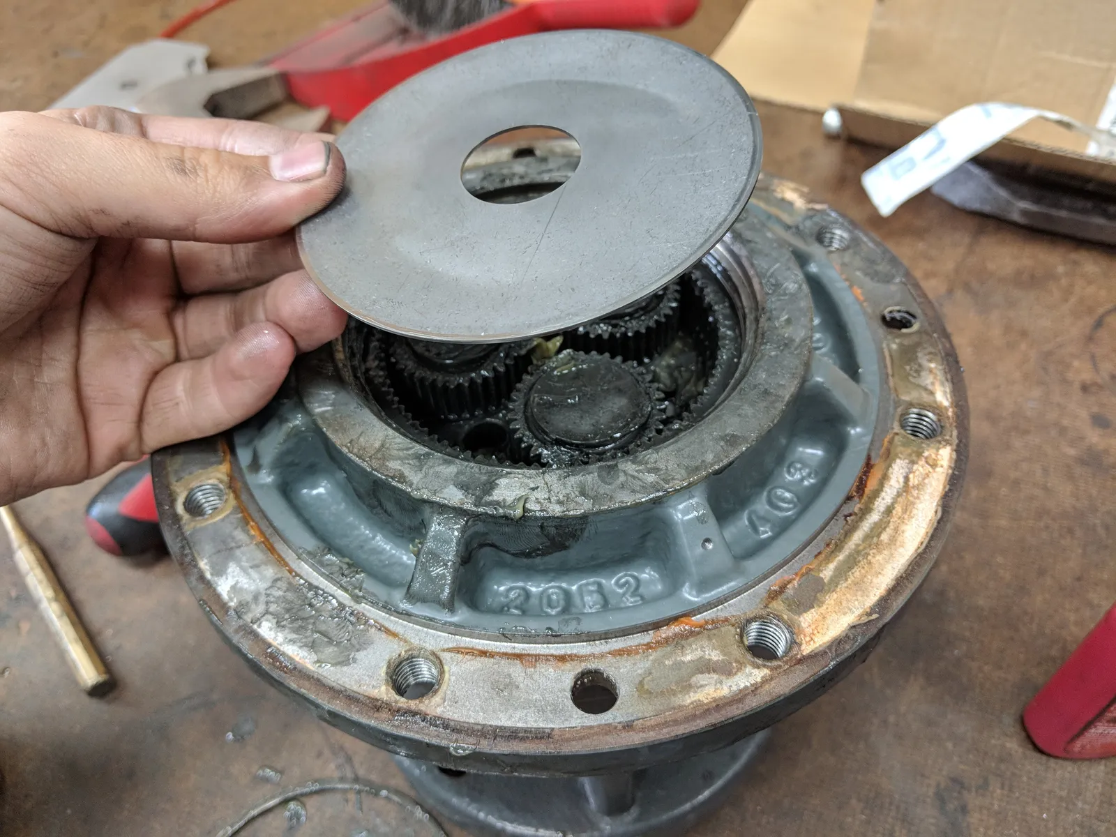 Steering motor gearbox opened up showing planetary gears and the cover plate