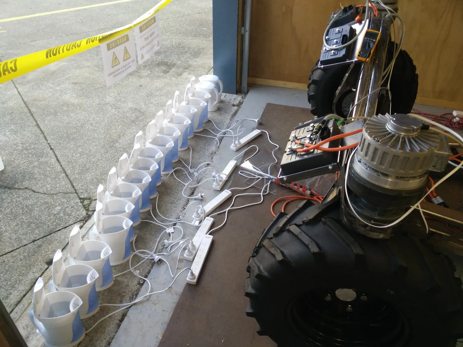 The platform with fifteen electric jugs wired in parallel as an improvised load bank