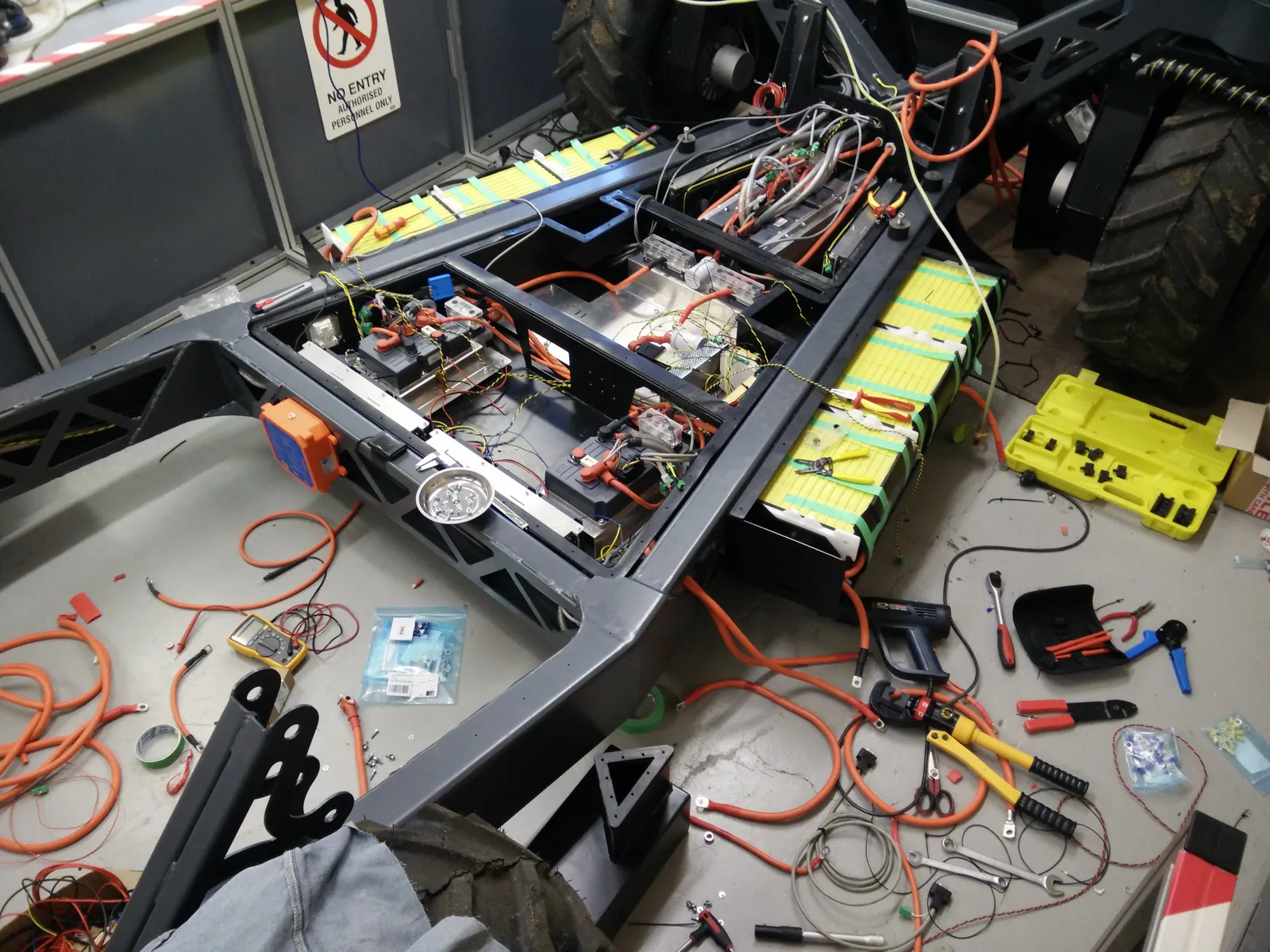 Top-down view inside the chassis during wiring, with LiFePO4 battery packs and controllers